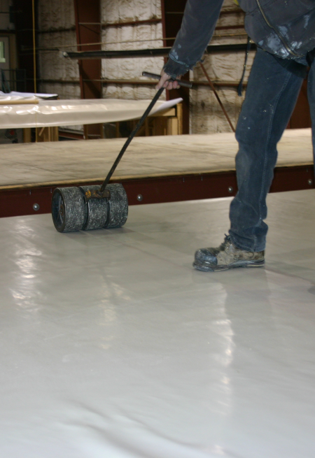 PVC Modular C3 MembraneCustomer install in progress: rolling membrane into adhesive to remove air bubbles.